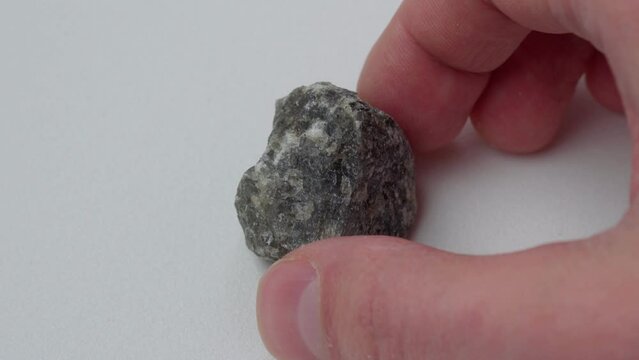 Raw labradorite of natural mineral from geological collection. White background