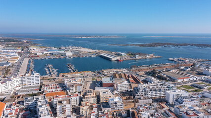 Fototapeta premium Aerial view of the Portuguese fishing tourist town of Olhao overlooking the Ria Formosa Marine Park. fishing port of fish trade