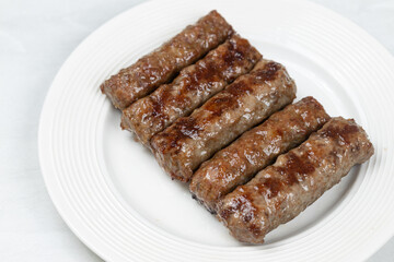 Fresh baked kebabs with minced meat served on the plate