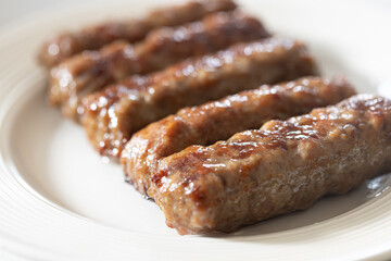 Fresh baked kebabs with minced meat served on the plate