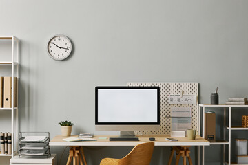 Minimal office setup with computer screen mockup on desk