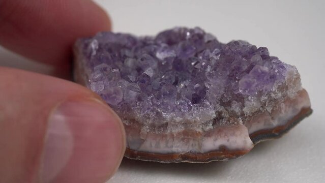 Crystal stone is a mineral. Purple rough amethyst quartz crystals, white background