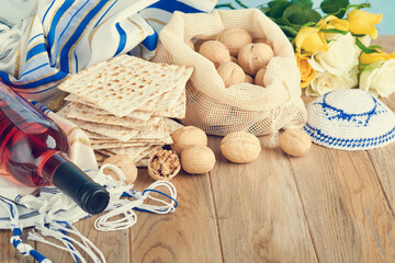 Passover celebration concept. Matzah, red kosher and walnut. Traditional ritual Jewish bread...