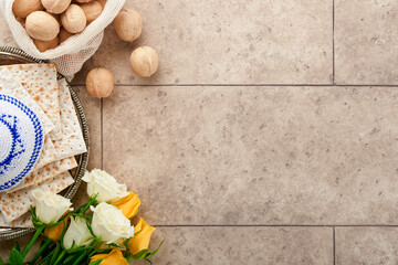 Passover celebration concept. Matzah, kosher red wine, walnut and white and yellow roses....