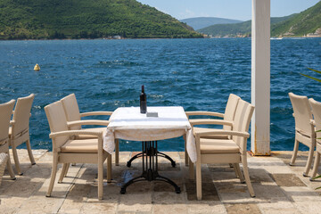 Fototapeta na wymiar Typical seaside restaurant overlooking the beautiful Bay of Kotor in Montenegro. Europe