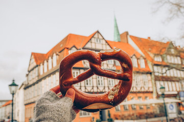 Pretzel and a typical german house in the background- Hannover, Lower Saxony, Germany, Europe