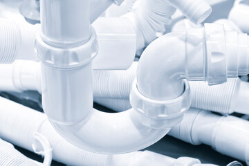 Plumbing sanitary white plastic sewer pipes siphons overflows for bathroom and sink.