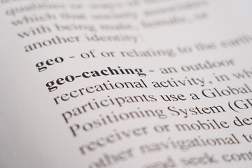 A closeup mockup of a dictionary of the word Geo-Caching