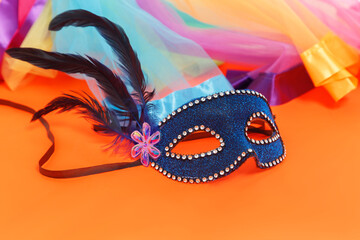 Multicolored carnival mask on blue background. Purim.