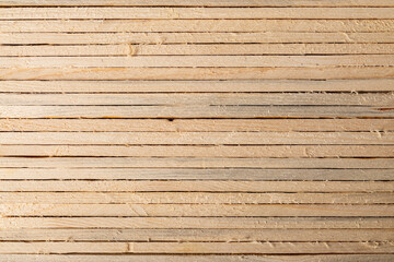A wall made of wooden slats made of raw wood.