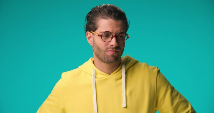 young casual man feeling disappointed to hear the news and slapping his forehead