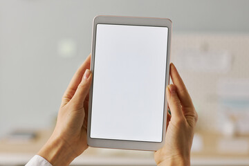 Hands holding digital tablet with white screen mock up