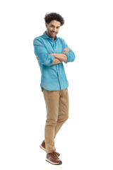handsome arab man in denim shirt crossing arms and smiling