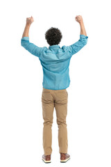back view of curly hair guy holding arms above head and cheering