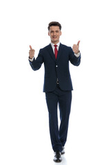 businessman walking and giving a thumbs up