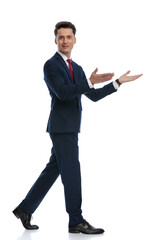 businessman walking and pointing the way