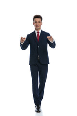 businessman walking and pointing at the camera