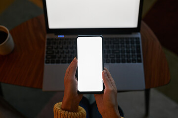 Top view closeup young woman using laptop and smartphone mockups