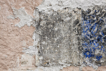 Cracked and damaged cement wall with different colors, like blue, grey, black and white, no person,...