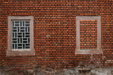 Fototapeta premium brick wall with an glas window and an bricked up window