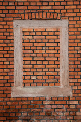 Red brown brick wall with bricked up window, no person and vertical format background