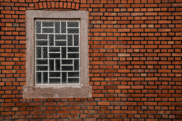 Fototapeta na wymiar Glass brick window in brick wall with space for text and bakcground, no person