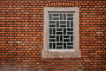 Glass brick window on brick wall, sbackground with pace for text, no person