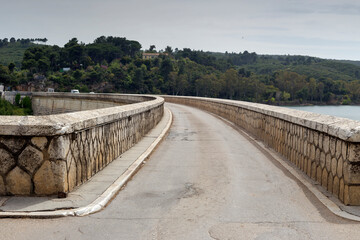 Fototapeta na wymiar A view of the reservoir lake Marathon (Greece) bridge on a sunny, spring day