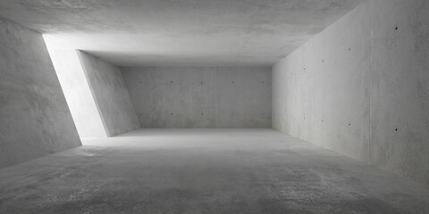 Abstract large, empty, modern concrete room, light from opening in sloped left wall and rough floor - industrial interior background template