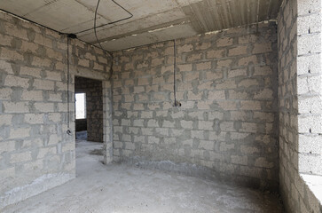 Construction of an individual residential building, view of the walls of the room between the doorway and the window