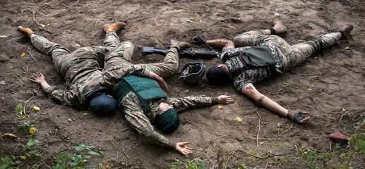 Wounded soldiers lie on the battlefield