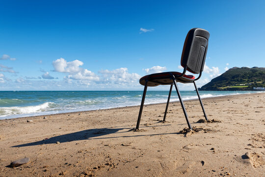 Unusual Scene With Empty Office Chair On The Beach. Concept Illustrating The Opportunity To Work Remotely.