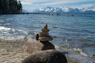 Stack of rocks on the beach of a mountain lake