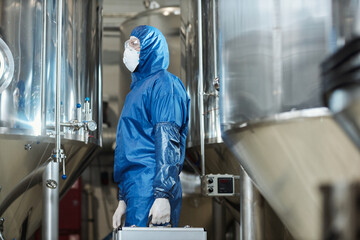 Worker wearing protective gear in chemical factory