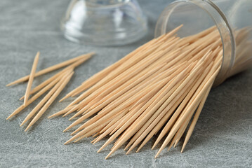 Pack of toothpicks falling out of plastic jar - Powered by Adobe