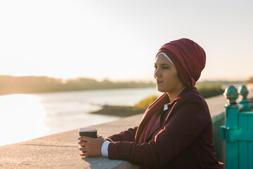 Portrait arab woman in hijab drinking coffee in cafe outdoors, copy space and empty place for text