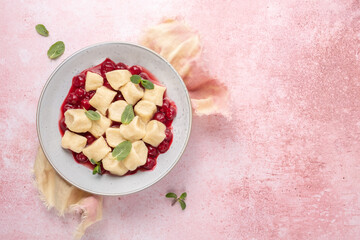 Portion of lazy dumplings vareniki with cherry sauce