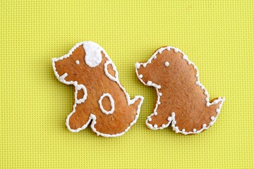 Gingerbread dogs decorated with white icing, bright yellow background