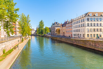 Historic buildings along the Ill River near Pont du Corbeau Bridge in the downtown district near the old town of Strasbourg, France.
