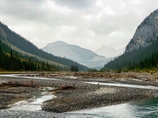 A northern view of river and mountains from Weeping Wall of Saskatchewan River Crossing in Kananaskis Country (Claresholm), Alberta, Canada.