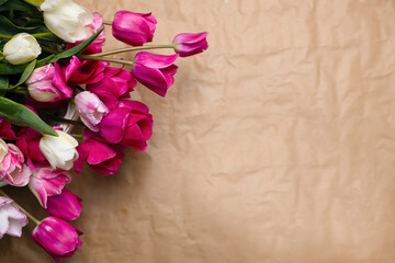 Pink and white tulips on a brown background with space for a copy. Postcard for congratulations on Mother's Day, March 8, birthday. Photography and pink flowers, romantic, date