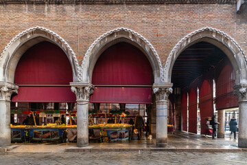 Market scene with sellers and shoppers in the Mercato di Rialto, in Venice, Veneto, Italy