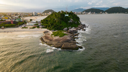 Huge stones at the water's edge in the city of Guaratuba at the end of the day, on the coast of...