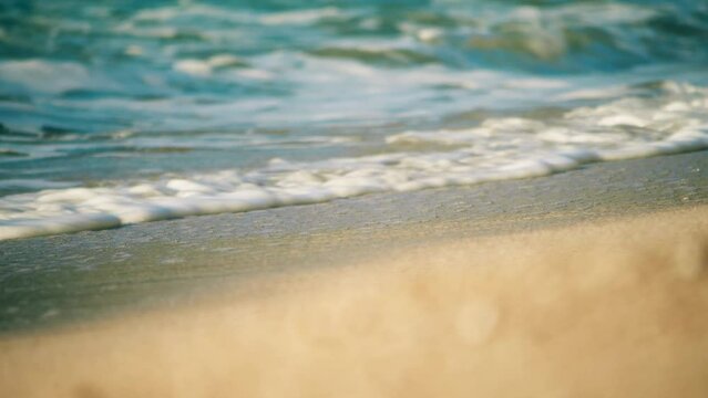 Splashing waves on the beach, tele lens slow motion shot