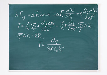 Equations written in chalk on blackboard.