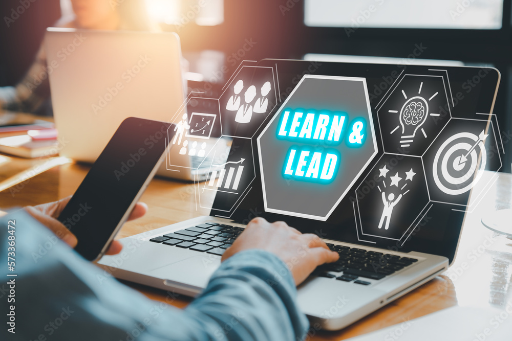 Poster learn and lead concept, person using laptop computer with learn and lead icon on vitual screen.