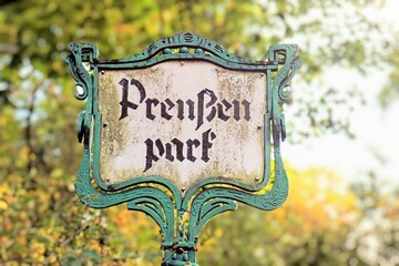 Entrance sign of the Preußenpark also known as Thai Park in Berlin Wilmersdorf, with Asian street...