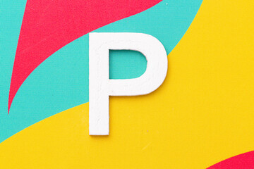 Letter P of the alphabet on colored background, top view