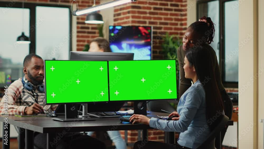 Poster team of diverse workers analyzing computers with greenscreen template, women looking at mockup displ