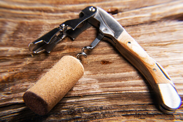 corkscrew and cork close-up on a textured wooden background. macro. Selective focus.